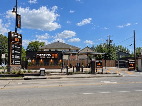 Station 33 storefront, roadside sign, and car wash entrance on Almeda Rd in Houston