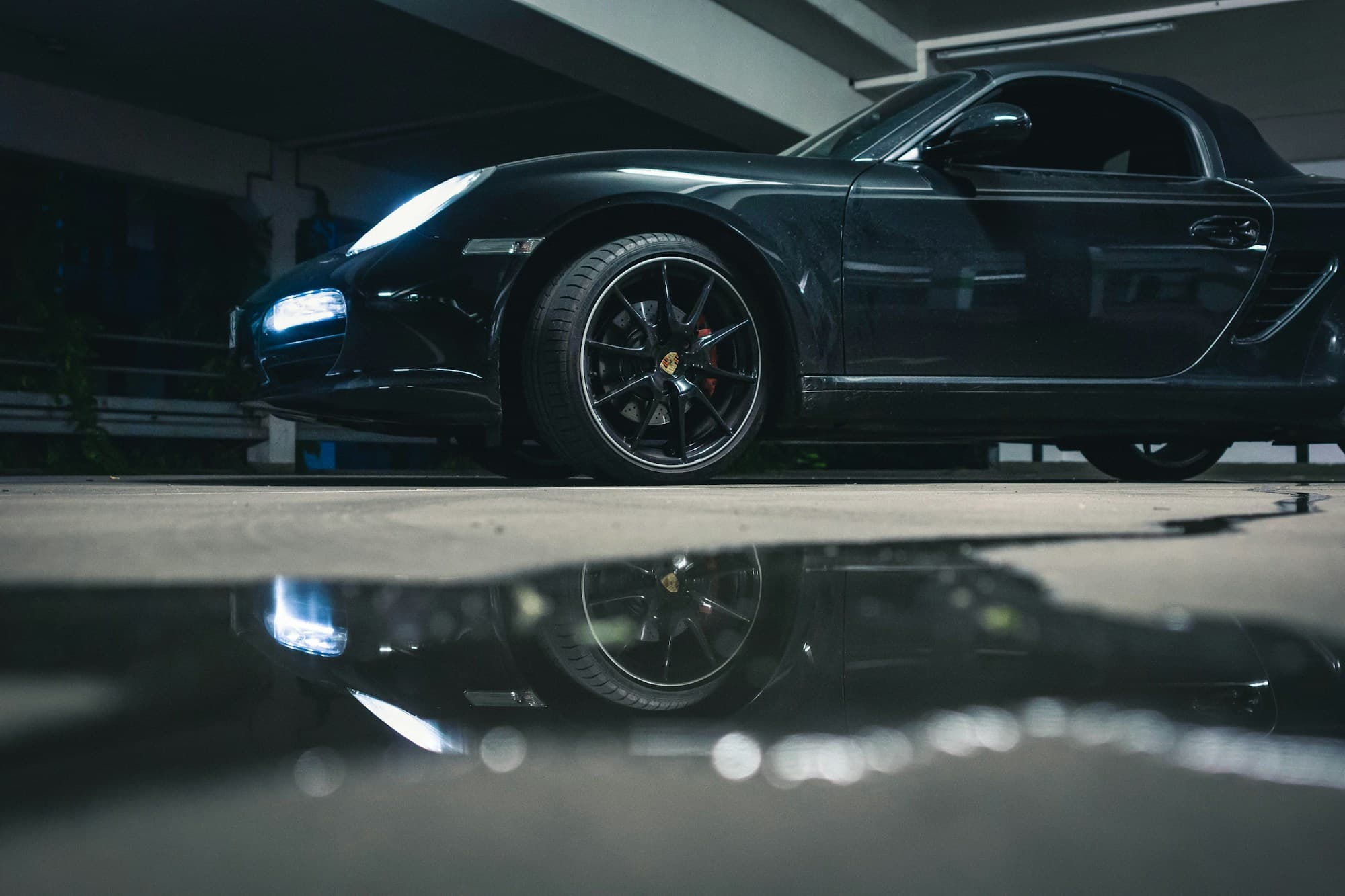 A black sports car with a polished exterior in a garage; illustrative automotive photography